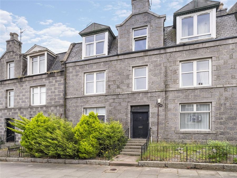 Stone townhouse with a black front door — a current Simpson & Marwick city listing