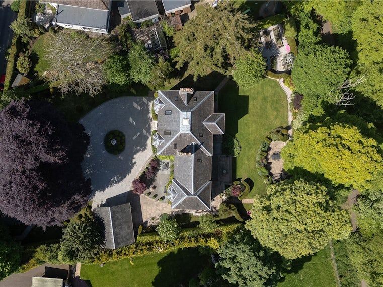 Aerial view of a country house and its gardens — a current Simpson & Marwick rural listing