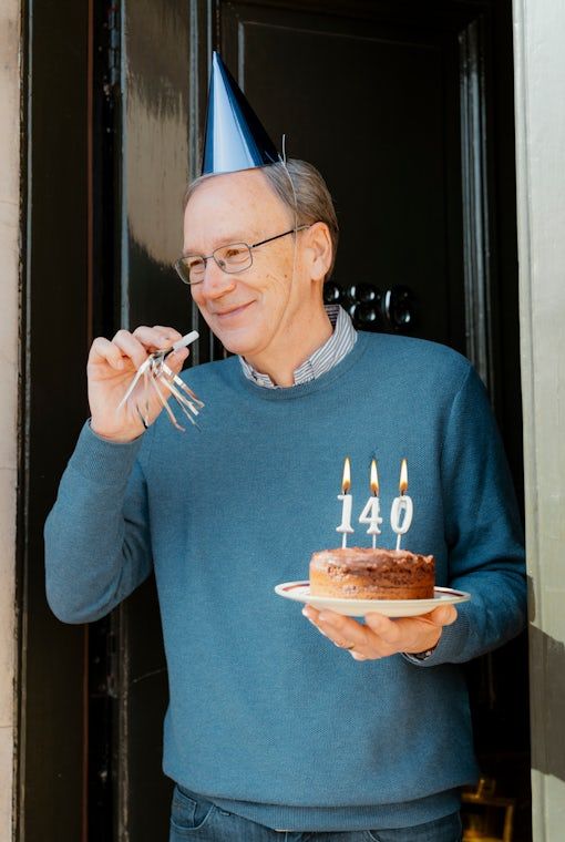 Celebrating 140 years at the front door — cake, keys and a Georgian doorway